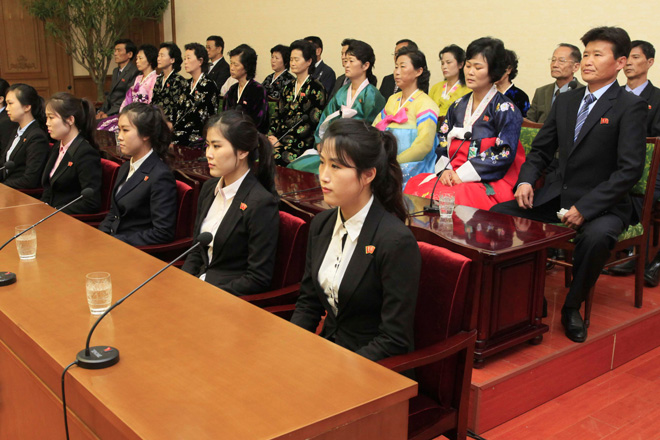 Colleagues and family members of 12 North Korean waitresses are presented to the media in Pyongyang on May 3