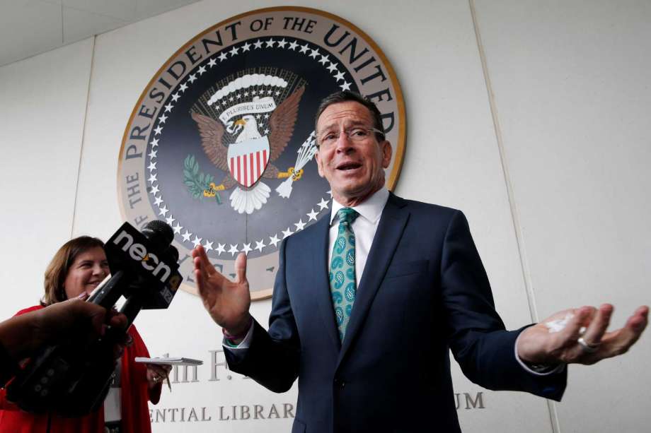 Connecticut Gov. Dannel P. Malloy speaks with reporters after receiving the John F. Kennedy Profile in Courage Award at the John F. Kennedy Presidential Library in Boston Sunday