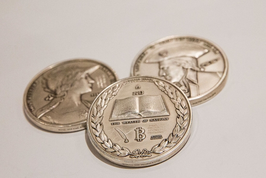 Silver coins with the Bitcoin logo on them