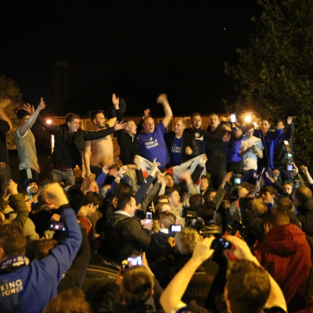 Crowds celebrate outside the home of Jamie Vardy after Leicester City win the Premier League