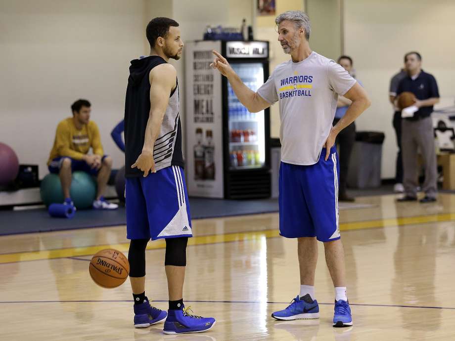 Golden State Warriors Stephen Curry left speaks with player development coach Bruce Fraser during NBA basketball practice on Thursday