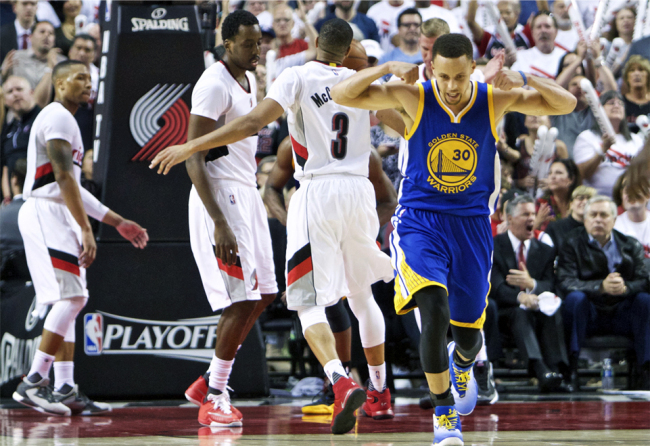 Golden State Warriors guard Stephen Curry reacts after scoring a basket against the Portland Trail Blazers during the second half of Game 4 of an NBA basketball second-round playoff series Monday