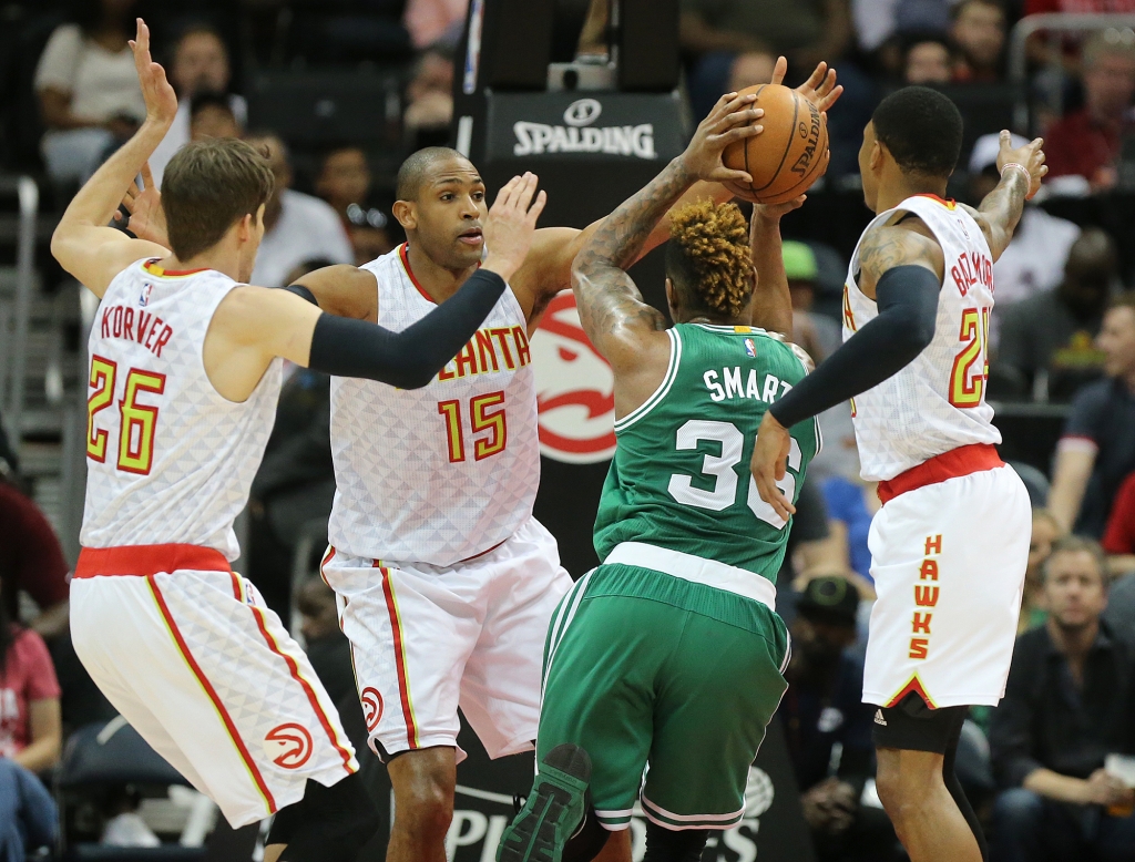 Atlanta Hawks Kyle Korver  Al Horford and Kent Bazemore right triple team Boston Celtics Marcus Smart during the first half of an NBA playoff basketball game Tuesday