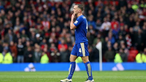 Danny Drinkwater walks dejectedly off the pitch after his red card at Old Trafford