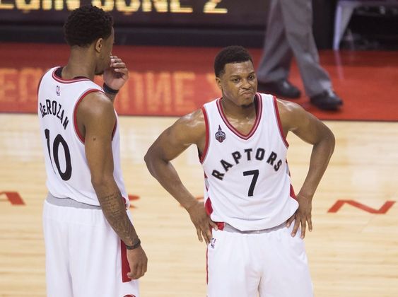 Kyle Lowry stands next to teammate De Mar DeRozan during the second half of Game 6 of the NBA basketball Eastern Conference finals Friday