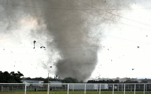 Debris flies through the air as a tornado rips through a residential area south of Wynnewood Oklahoma