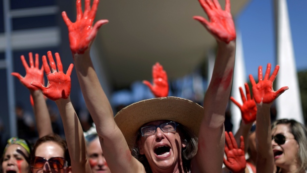 Demonstrators attend a protest against rape and violence against women in Brasilia on Sunday