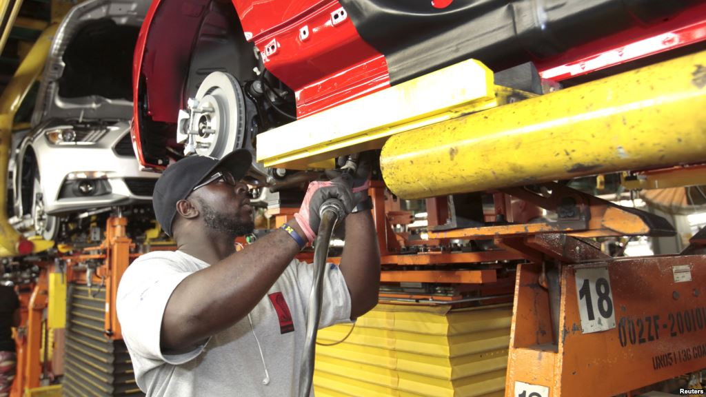 FILE- An assembly worker works on 2015 Ford Mustang vehicles on the production line at the Ford Motor Flat Rock Assembly Plant in Flat Rock Michigan Aug. 20 2015