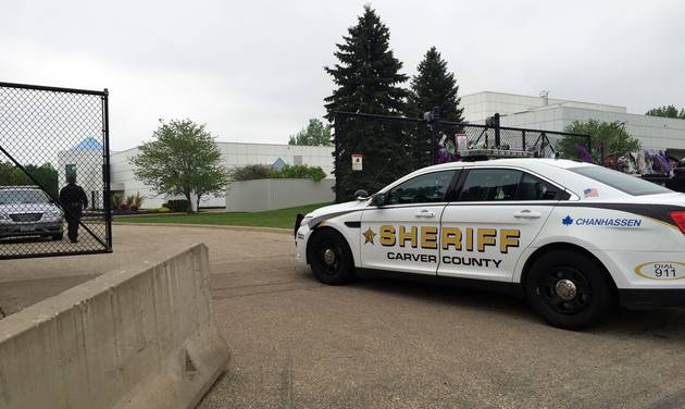 A Carver County sheriff’s vehicle enters through the gates of Prince's Paisley Park home and studio in Chanhassen Minn. Tuesday