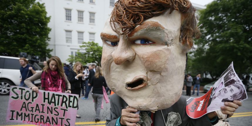 A masked protester demonstrates outside Republican National Committee headquarters where Republican U.S. presidential candidate Donald Trump was meeting with House Speaker Paul Ryan and RNC Chairman Reince Priebus in Washington D.C. on May