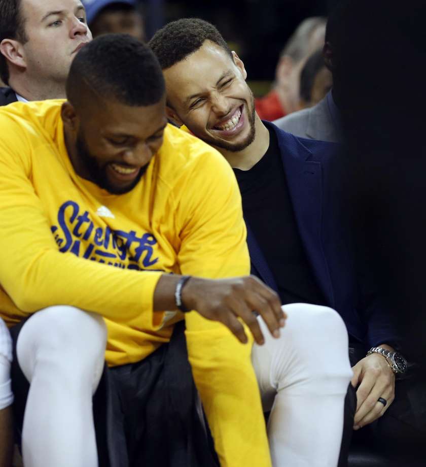 Golden State Warriors Stephen Curry and Festus Ezeli enjoy themselves in 2nd quarter against Portland Trail Blazers during Game 1 of NBA Playoffs Western Conference Semifinals at Oracle Arena in Oakland Calif. on Sunday