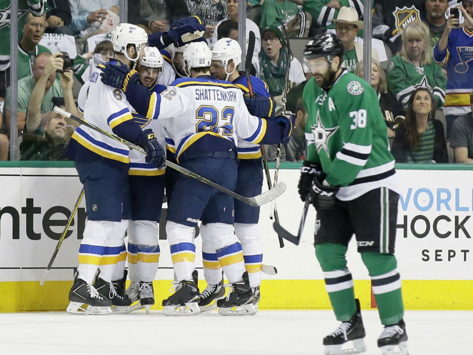 Dallas Stars centre Vernon Fiddler skates off the ice as Blues centre Robby Fabbri celebrates his goal with teammates