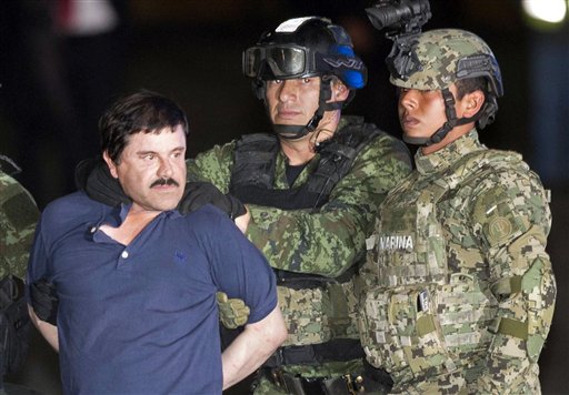 Joaquin'El Chapo Guzman is made to face the press as he's escorted to a helicopter in handcuffs by soldiers and marines at a federal hangar in Mexico City. Guzman's second prison escape in 2015 from a top