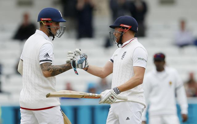 England's Jonny Bairstow right celebrates his half century with Alex Hales