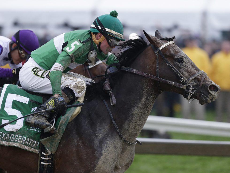 Exaggerator with Kent Desormeaux aboard moves past Nyquist during the Preakness Stakes on Saturday in Baltimore