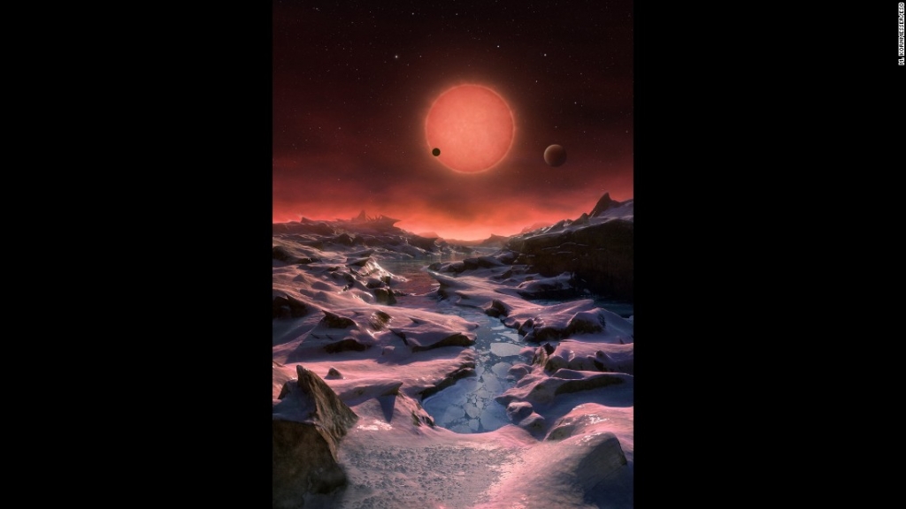 This artist's impression shows an imagined view from the surface one of the three planets orbiting an ultracool dwarf star just 40 light-years from Earth that were discovered using the TRAPPIST telescope at ESO's La Silla Observatory. Given the