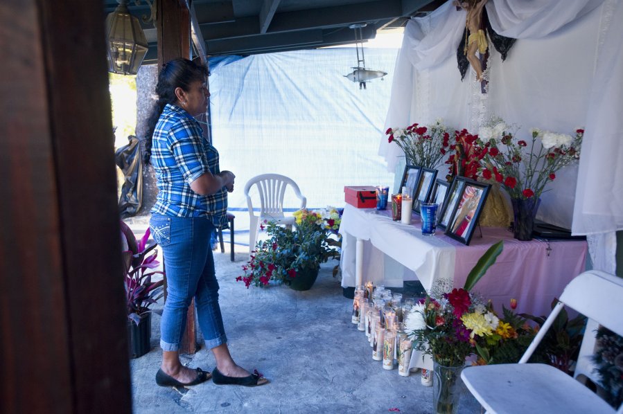 Crisanta Perez of Stuart looks over the candlelight vigil honoring the lives of four of her grandchildren on Monday at her home in Stuart. Perez's daughter Heidi Solis Perez  lost control of the minivan she was driving Saturday night whe