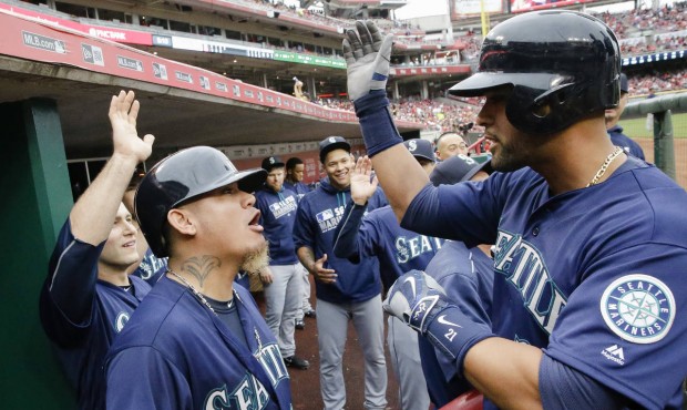 Felix Hernandez greets Franklin Gutierrez in the dugout after his homer in the Mariners win Saturday