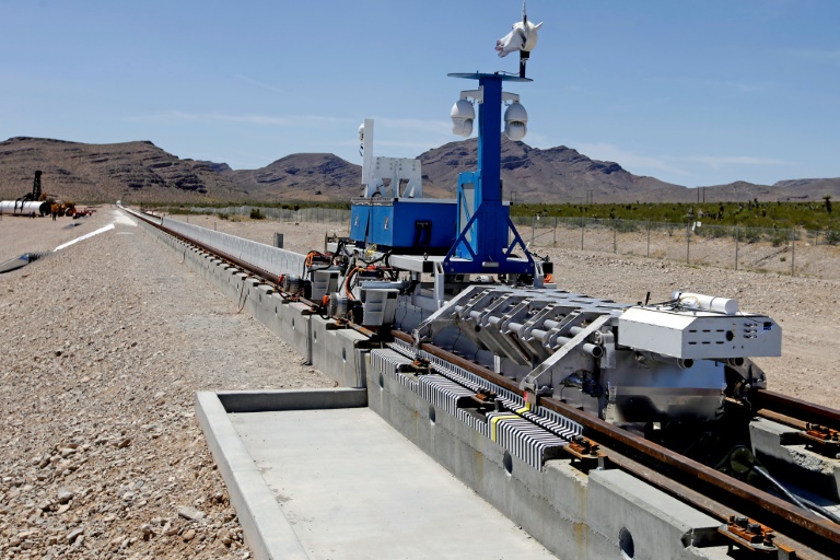 AFP  John GurzinskiA recovery vehicle and a test sled sit on rails after the first test of the propulsion system at the Hyperloop One Test and Safety site