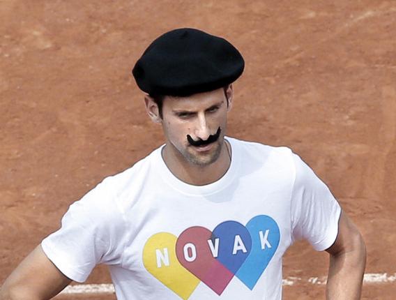 When in Paris:Novak Djokovic began his latest bid to complete a career Grand Slam in a beret and a false moustache playing petanque — a recreational French game akin to bowling — before a training session