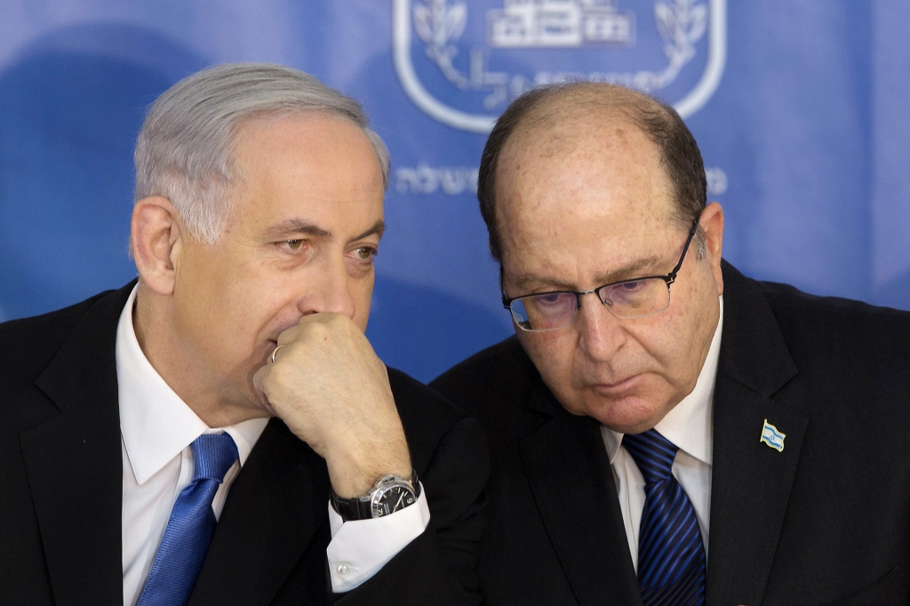 Israeli Prime Minister Benjamin Netanyahu left speaks with Israel's Defense Minister Moshe Yaalon during a ceremony for new Israeli Chief of Staff Gadi Eizenkot at the Prime Minister's office in Jerusal