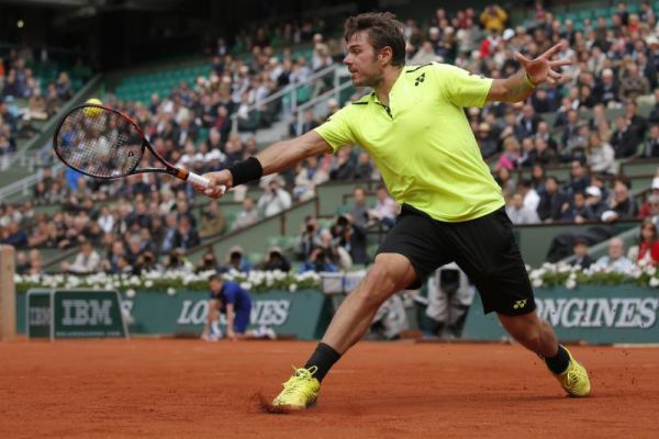 Defending champion Switzerland's Stan Wawrinka returns the ball