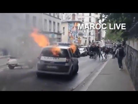 A video has emerged of the shocking moment protesters attacked and set on fire a police car in central Paris on Tuesday forcing the two officers inside to flee the vehicle as it burst into flames