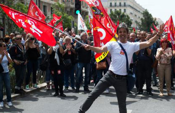 People holding French CGT union take part in a demonstration against the French government’s planned labor law reforms in front of Les Terrasses du Port commercial center in Marseille France on Thursday. — AFP