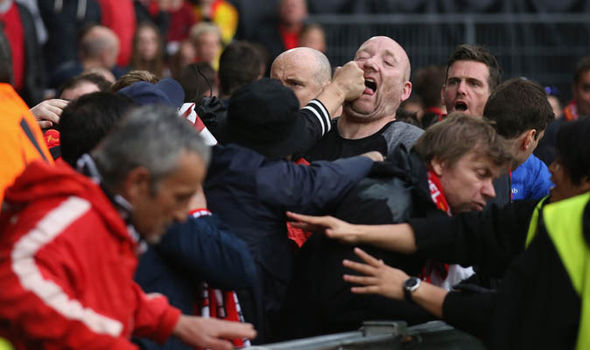 A fan is punched during the mass brawl