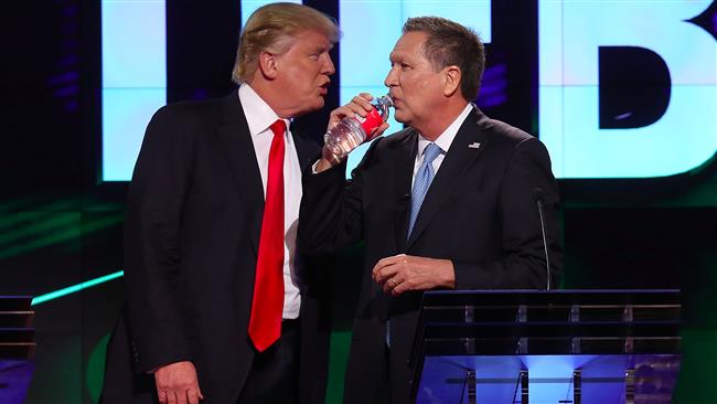 GOP front-runner Donald Trump speaks to Ohio Governor John Kasich during a Republican debate