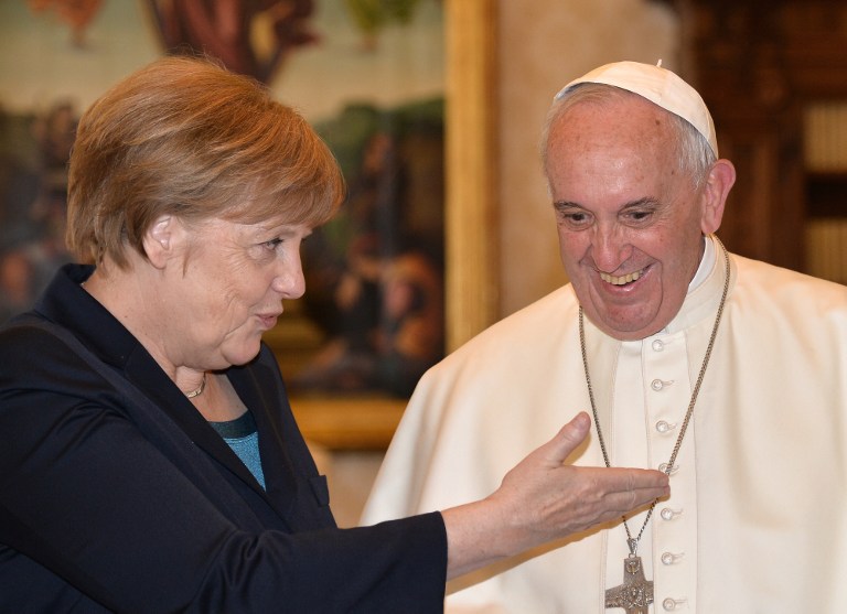 German Chancellor Angela Merkel talks with Pope Francis during a private audience