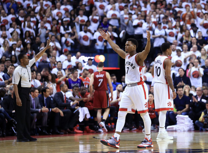 Kyle Lowry of the Raptors celebrates late in Game 7 against the Heat with Toronto fans eager to face Cleveland in the East final