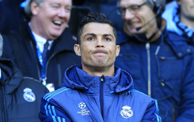 Real Madrid's Cristiano Ronaldo watches the math at the bench during the Champions League semifinal soccer match between Manchester City and Real Madrid at the City of Manchester stadium in Manchester England Tuesday