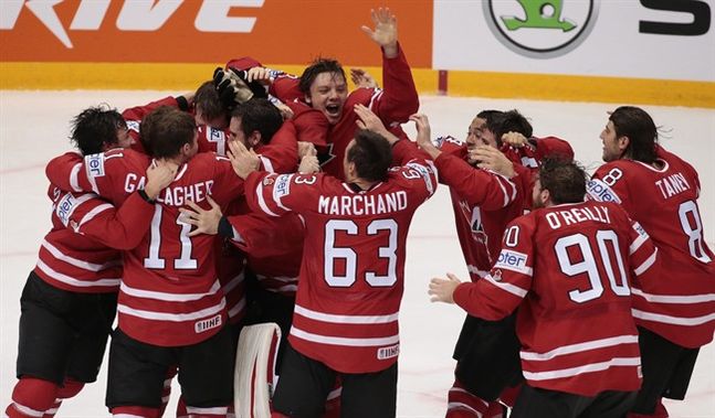 Canada's players celebrate the victory goal during the Ice Hockey World Championships final match between Finland and Canada in Moscow Russia on Sunday