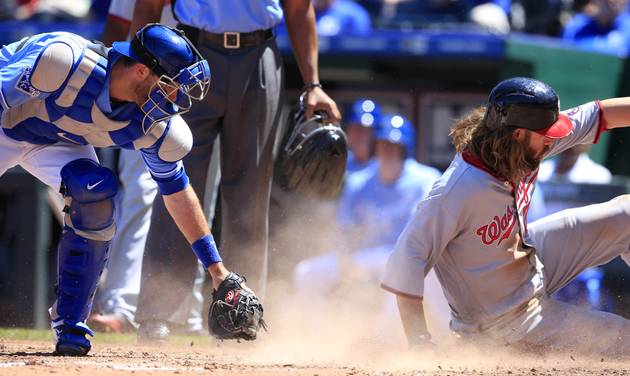 Washington Nationals&#039 Jayson Werth right scores past the missed tag by Kansas City Royals catcher Drew Butera left during the third inning of a baseball game at Kauffman Stadium in Kansas City Mo. Wednesday