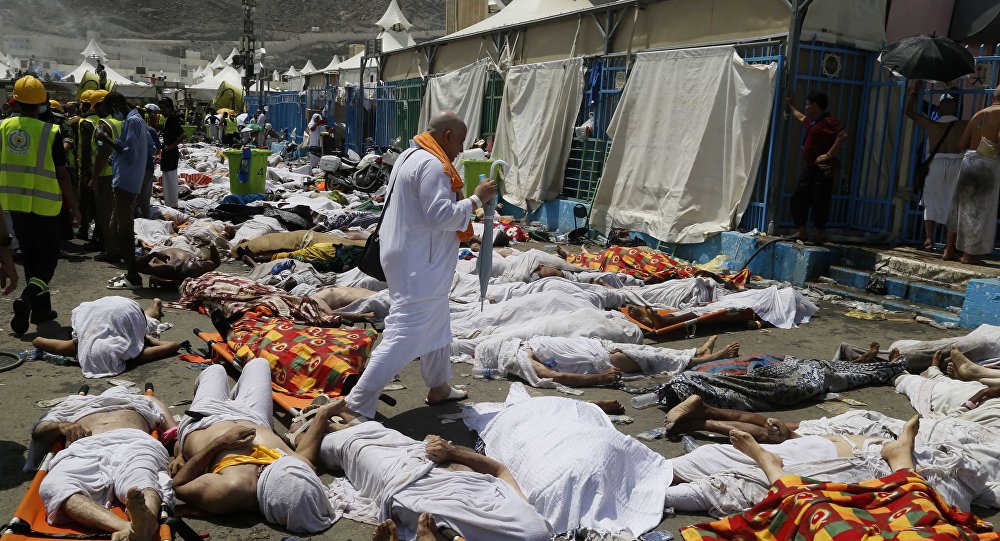 Muslim pilgrim walks through the site where dead bodies are gathered after a stampede during the annual hajj pilgrimage in Mina Saudi Arabia