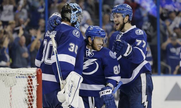 Tampa Bay Lightning's goalie Ben Bishop is congratulated by Jonathan Marchessault and Victor Hedman, of Sweden at the end of the third period of Game 5 of the NHL hockey Stanley Cup Eastern Conference semifinals against the New York I