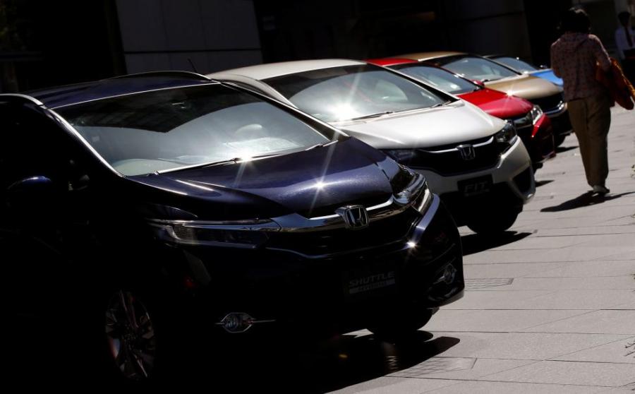 Honda reports quarterly loss on strong yen, air-bag recall