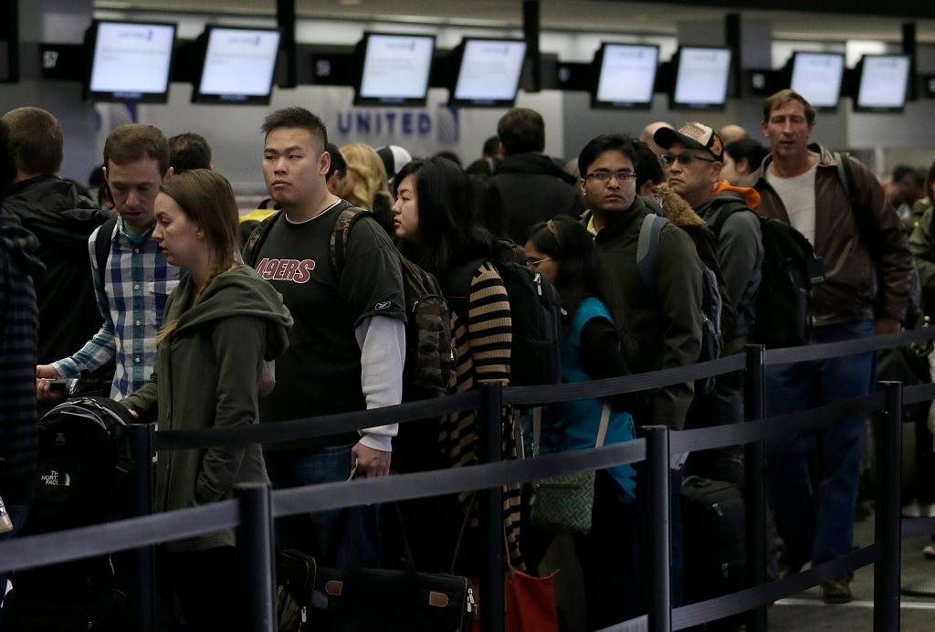 A line of passengers wait in line to enter the security checkpoint in the domestic terminal at San Francisco International Airport in San Francisco Thursday Nov. 28 2013. More than 43 million people are to travel over the long holiday weekend accordin