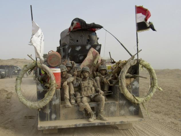 Iraqi pro-government fighters hold position in al Shahabi village east of Fallujah on Wednesday as part of a major assault to retake the city from Islamic State