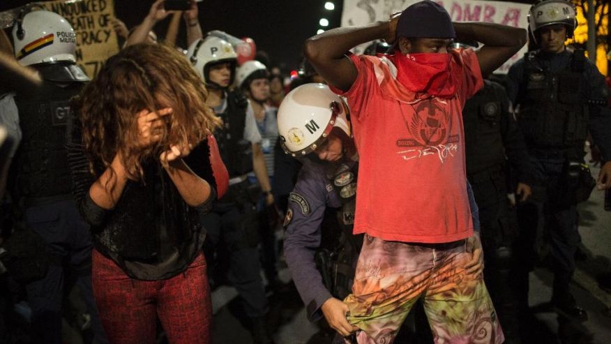 A pro-government supporter is frisked after clashing with the police when he attempted to advance towards the Congress building in Brasilia Brazil Wednesday