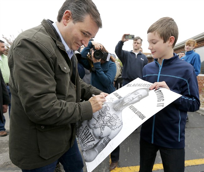 Republican presidential candidate Sen. Ted Cruz R Texas autographs a poster outside the Bravo Cafe during a campaign stop Monday