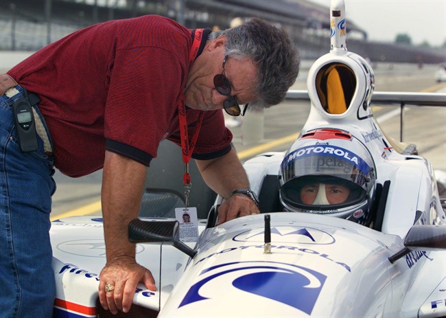 Mario Andretti left chats with his son Michael during practice at Indianapolis Motor Speedway in Indianapolis. In the lead-up to the 100th running of the