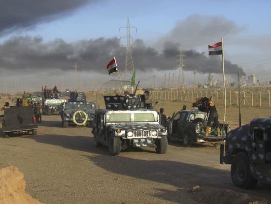 Iraqi security forces and allied Shiite Popular Mobilization Forces and Sunni tribal fighters take combat positions outside Fallujah west of Baghdad on May 23. /Rwa Faisal  AP