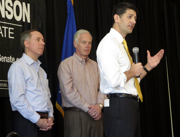 House Speaker Paul Ryan joins Wisconsin state Assembly Speaker Robin Vos left and Sen. Ron Johnson R-Wis. center at a campaign rally for Johnson on Thursday