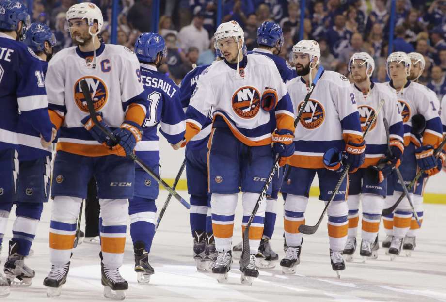 The New York Islanders congratulate the Tampa Bay Lightning at the end of Game 5 of the NHL hockey Stanley Cup Eastern Conference semifinals Sunday