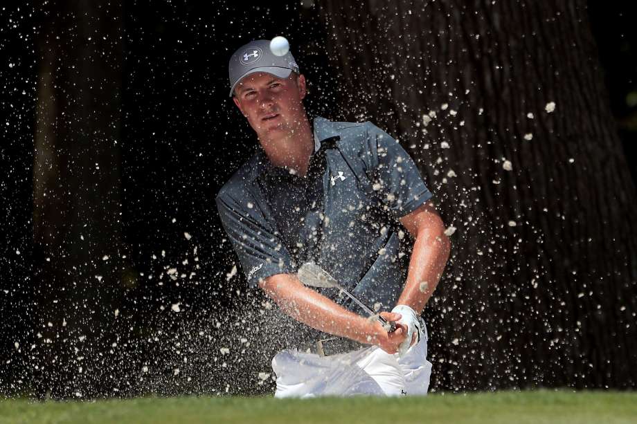 Jordan Spieth hits a shot out of the bunker on No. 8