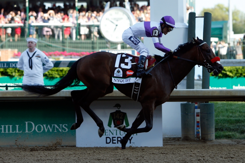 LOUISVILLE KY- MAY 07 Nyquist #13 ridden by Mario Gutierrez crosses the finish line to win the 142nd running of the Kentucky Derby at Churchill Downs