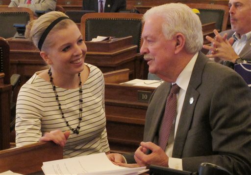 Kansas House Speaker Ray Merrick right a Stilwell Republican confers with his communications director Rachel Whitten left during the chamber's session Friday