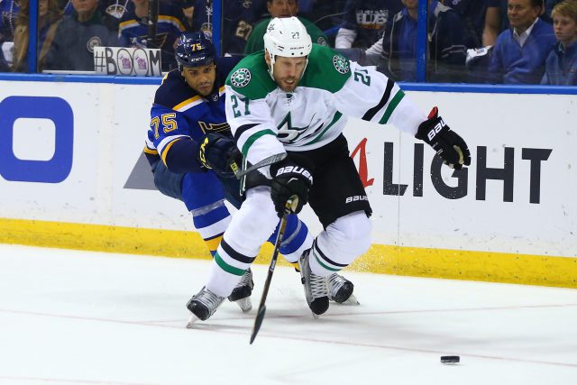 ST. LOUIS MO- MAY 5 Ryan Reaves #75 of the St. Louis Blues and Travis Moen #27 of the Dallas Stars chase the puck in Game Four of the Western Conference Second Round during the 2016 NHL Stanley Cup Playoffs at the Scottrade Center